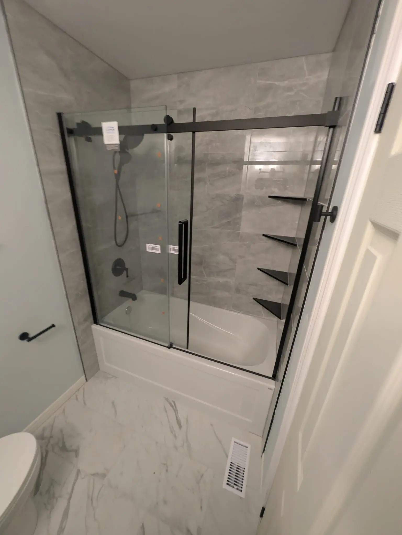 Bathroom Renovation — Fully renovated bathroom with quality tile and updated fixtures throughout.